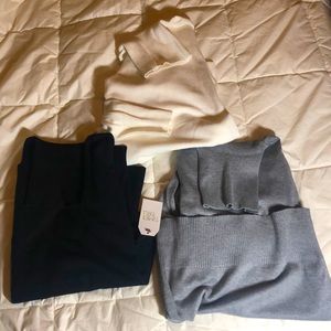 Set of three turtleneck sweaters.